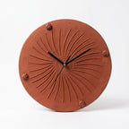 Terracotta sunburst wall clock hand-carved pinwheel relief natural clay 11 inch India Soul Of Soil